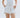 white linen shorts with applique coral detail, gold pocket charms, belt and paperbag waist.  asymmetrical hem.  lido luna. 