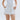 white linen shorts with applique coral detail, gold pocket charms, belt and paperbag waist.  asymmetrical hem.  lido luna. 