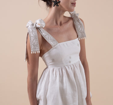 Beautiful Linen Babydoll Top with beading and embroidery designed by Fleur Kakasi.  Shoulder tie straps, adjustable fitting, and real freshwater pearl trim. 