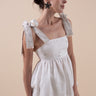 Beautiful Linen Babydoll Top with beading and embroidery designed by Fleur Kakasi.  Shoulder tie straps, adjustable fitting, and real freshwater pearl trim. 