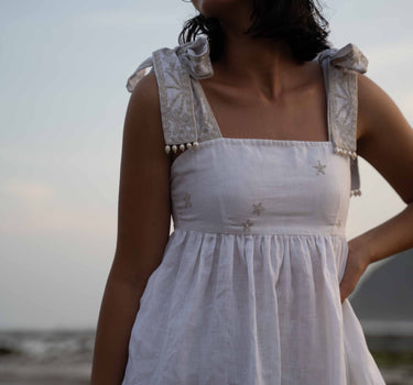 Beautiful Linen Babydoll Top with beading and embroidery designed by Fleur Kakasi.  Shoulder tie straps, adjustable fitting, and real freshwater pearl trim. 