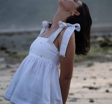 Beautiful Linen Babydoll Top with beading and embroidery designed by Fleur Kakasi.  Shoulder tie straps, adjustable fitting, and real freshwater pearl trim. 