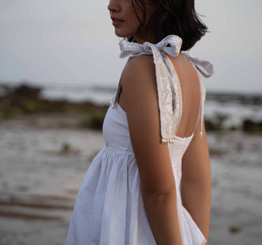 Beautiful Linen Babydoll Top with beading and embroidery designed by Fleur Kakasi.  Shoulder tie straps, adjustable fitting, and real freshwater pearl trim. 