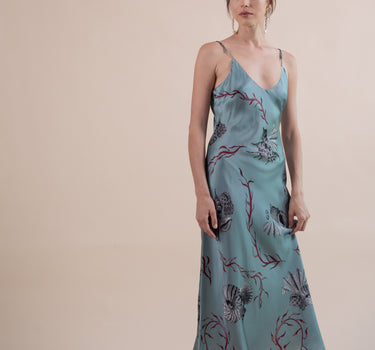 Beautiful luxurious pure silk slip dress gown in teal green with seashell and seaweed artwork designed by Fleur Kakasi.  Adjustable straps, mid-length. 