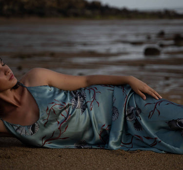 Beautiful luxurious pure silk slip dress gown in teal green with seashell and seaweed artwork designed by Fleur Kakasi.  Adjustable straps, mid-length. 