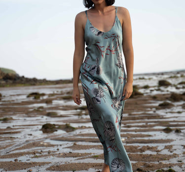 Beautiful luxurious pure silk slip dress gown in teal green with seashell and seaweed artwork designed by Fleur Kakasi.  Adjustable straps, mid-length. 