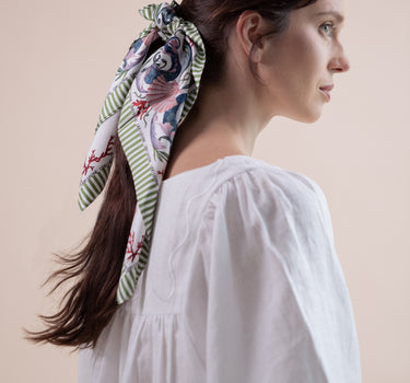 The Koi Carré scarf is a beautiful 100% silk twill square scarf.  Can worn as a headscarf, hair ribbon, on the wrist, or on your bag handle.