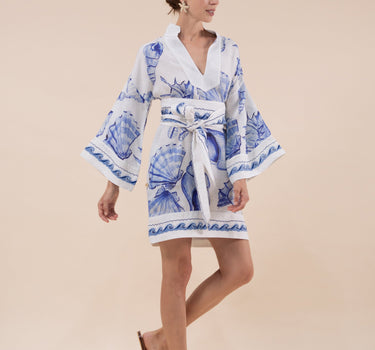 The Nerites dress is a short, popover style in 100% linen in a traditional but modernised kaftan style, with deep placket neckline and wide bell sleeves. Custom print by Fleur Kakasi, with hand embroidery and beading on the cuffs, hem, and double-length belt.
