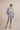 The Nerites dress is a short, popover style in 100% linen in a traditional but modernised kaftan style, with deep placket neckline and wide bell sleeves. Custom print by Fleur Kakasi, with hand embroidery and beading on the cuffs, hem, and double-length belt.