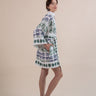 The Nerites dress is a short, popover style in 100% linen in a traditional but modernised kaftan style, with deep placket neckline and wide bell sleeves. Custom print by Fleur Kakasi, with hand embroidery and beading on the cuffs, hem, and double-length belt.