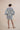The Nerites dress is a short, popover style in 100% linen in a traditional but modernised kaftan style, with deep placket neckline and wide bell sleeves. Custom print by Fleur Kakasi, with hand embroidery and beading on the cuffs, hem, and double-length belt.