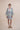The Nerites dress is a short, popover style in 100% linen in a traditional but modernised kaftan style, with deep placket neckline and wide bell sleeves. Custom print by Fleur Kakasi, with hand embroidery and beading on the cuffs, hem, and double-length belt.