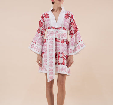 The Nerites dress is a short, popover style in 100% linen in a traditional but modernised kaftan style, with deep placket neckline and wide bell sleeves. Custom print by Fleur Kakasi, with hand embroidery and beading on the cuffs, hem, and double-length belt.