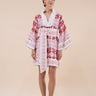 The Nerites dress is a short, popover style in 100% linen in a traditional but modernised kaftan style, with deep placket neckline and wide bell sleeves. Custom print by Fleur Kakasi, with hand embroidery and beading on the cuffs, hem, and double-length belt.