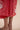 The Poseidon Wrap Skirt is a classic full-wrap style, below knee length, featuring extra long ties, and stunning applique and embroidery details on coral red linen. 
 The contrasting ivory applique features our signature coral motif, with glass pearl beads, and each tie features real natural baroque pearl charms at each end. Design by Fleur Kakasi