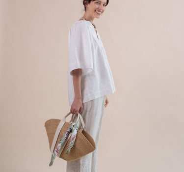 The Seamoss Top is a versatile, cool and breezy popover handkerchief linen top with beautiful seashell hand embroidery featuring glass pearl beads and accents. Design by Fleur Kakasi.