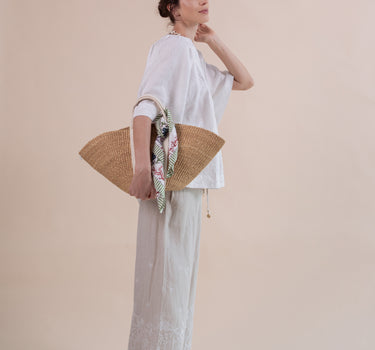 The Seamoss Top is a versatile, cool and breezy popover handkerchief linen top with beautiful seashell hand embroidery featuring glass pearl beads and accents. Design by Fleur Kakasi.